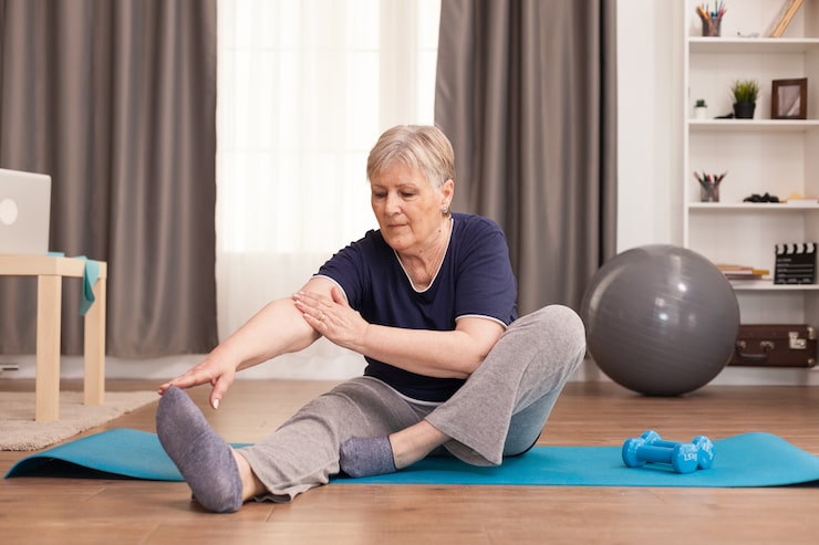 Senior woman performing safe osteoporosis exercises with weights and balance training